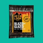 A bag of Blazed & Glazed beef jerky by Heirloom jerky that says it's sweet, spicy, and bleeping good.